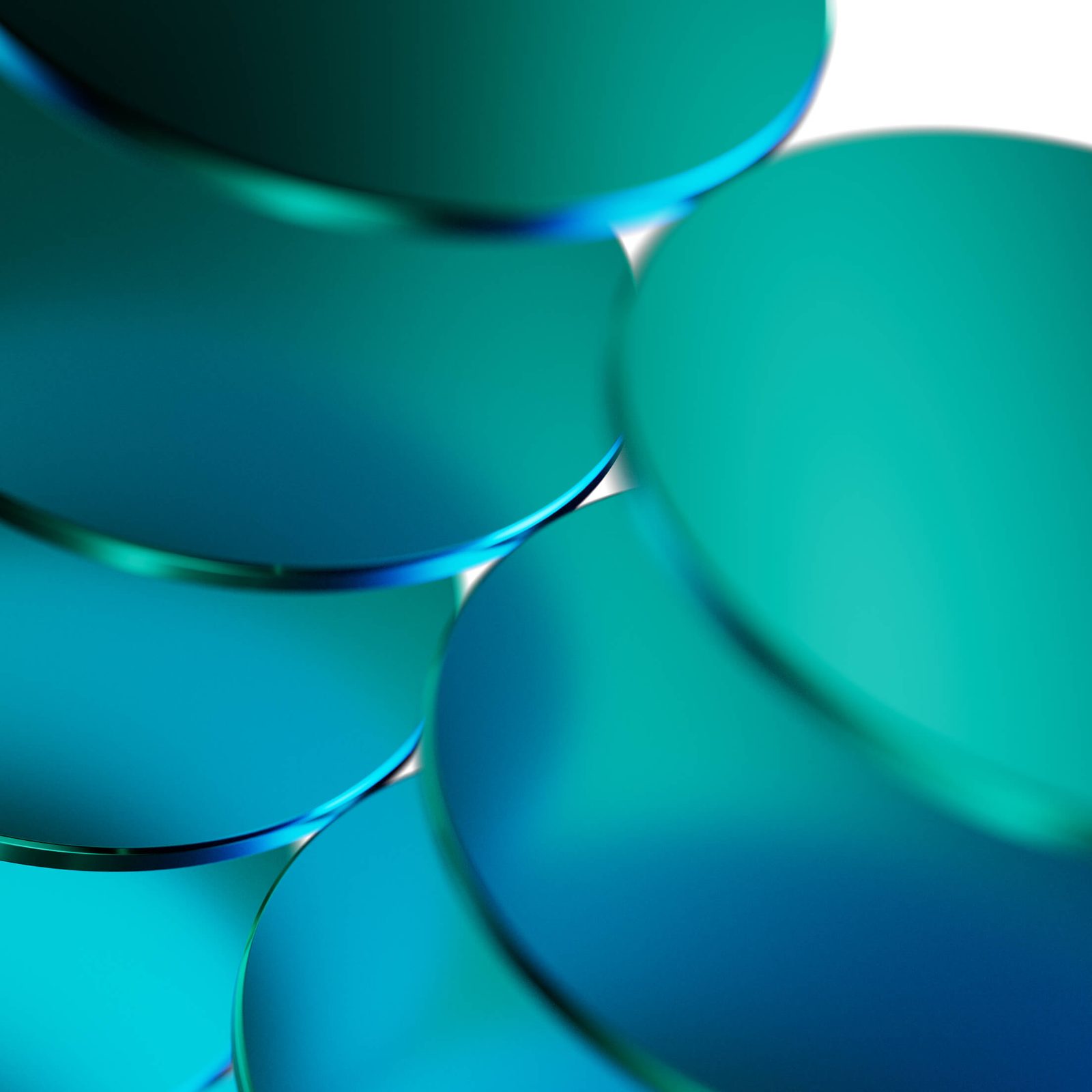 Abstract image of overlapping green and blue glass discs.